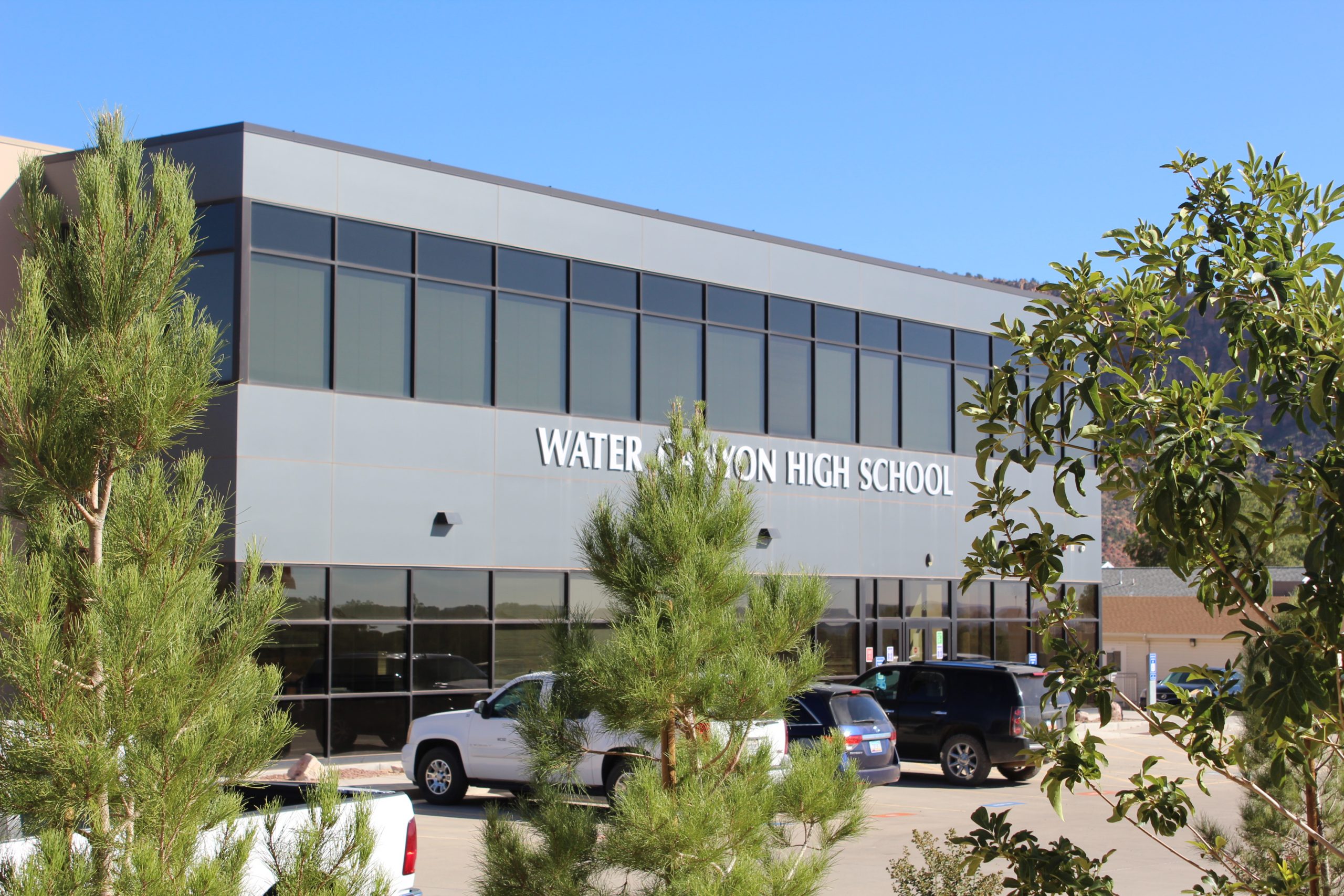 Water Canyon High School through pine trees